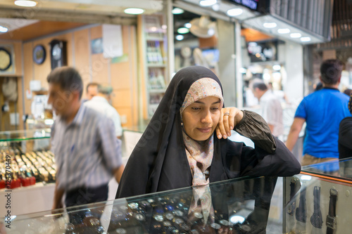 Beautiful Muslim woman spending time on traditional Iranian baza