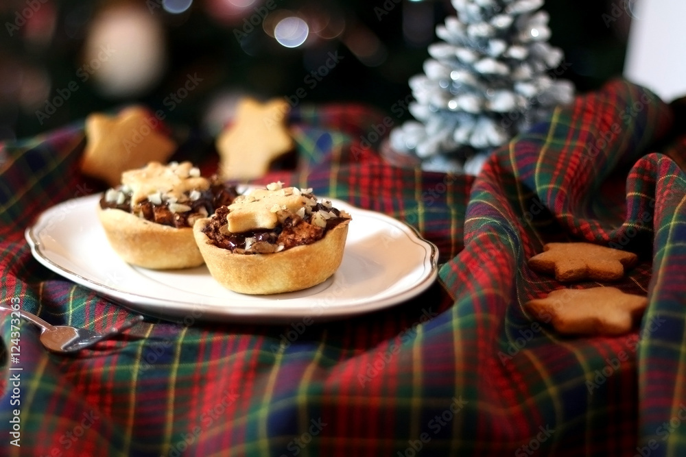 Christmas pastry filled with apples, almonds and chocolate with star shaped cookies. Selective focus and festive background.
