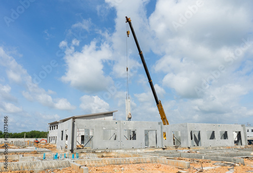 Construction site crane is used to placing precast concrete pane