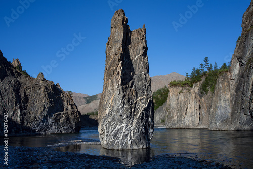 Single stone pillar in the riverbed. River Omulyovka. Magadan Region. Russia. photo