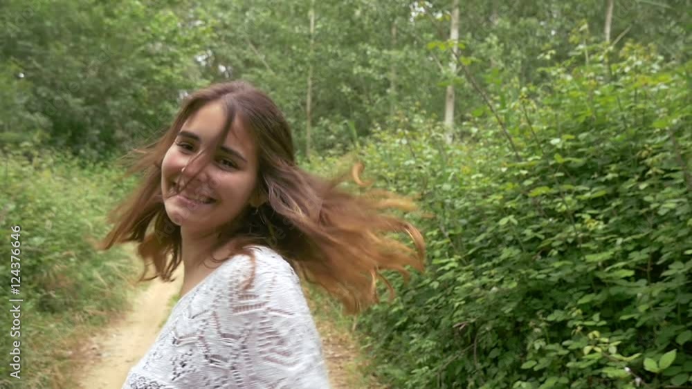 Beautiful girl young attractive woman in nature outdoors spinning smile happy and looking at camera relaxed fun emotion healthy girl smiling hipster look slowmotion slow motion Beautiful girl young attractive woman in nature outdoors spinning smile happy and looking at camera relaxed fun emotion healthy girl smiling hipster look slowmotion slow motion