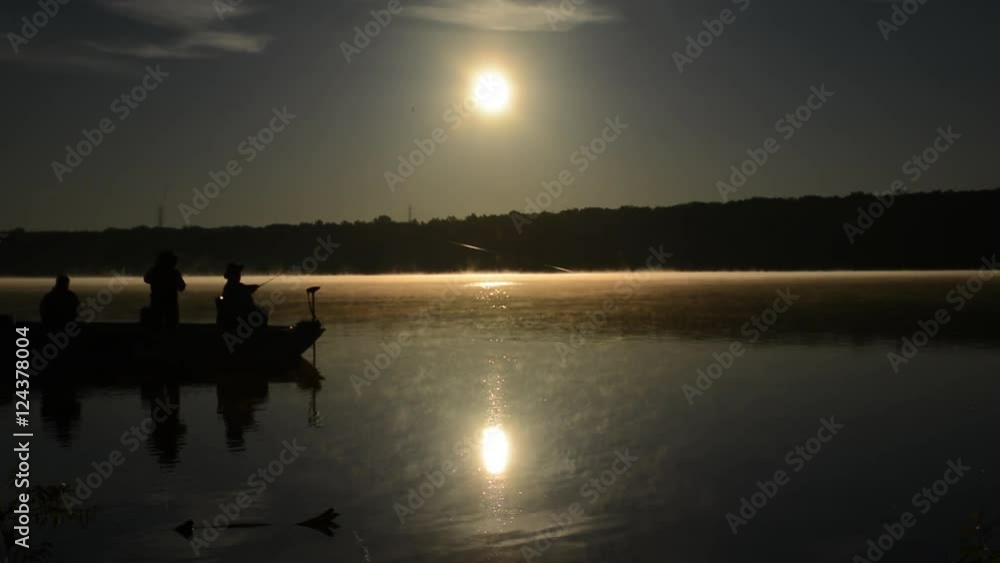 Silhouette of fishermen fishing off a small boat during sunrise on the Hoover Memorial Reservoir, Hoover Dam Ohio nature beauty shot. Silhouette of fishermen fishing off a small boat during sunrise on the Hoover Memorial Reservoir, Hoover Dam Ohio nature beauty shot.