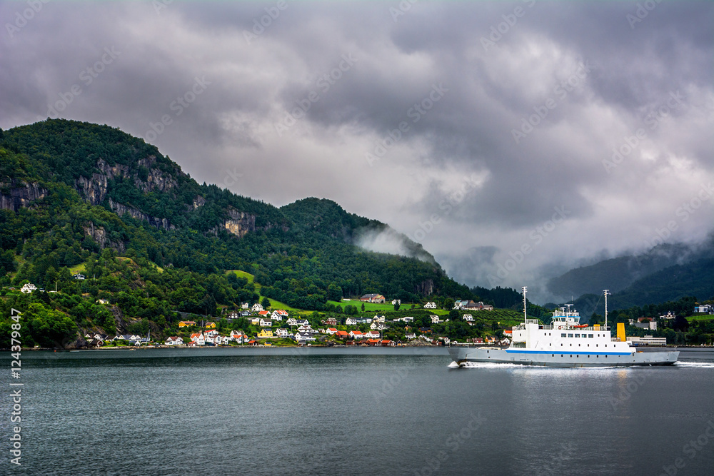 Amazing view with fjord, foggy mountains and ferry. Norway