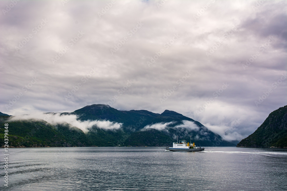Amazing view with fjord, foggy mountains and ferry. Norway