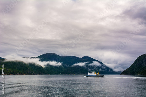 Amazing view with fjord, foggy mountains and ferry. Norway © olenatur