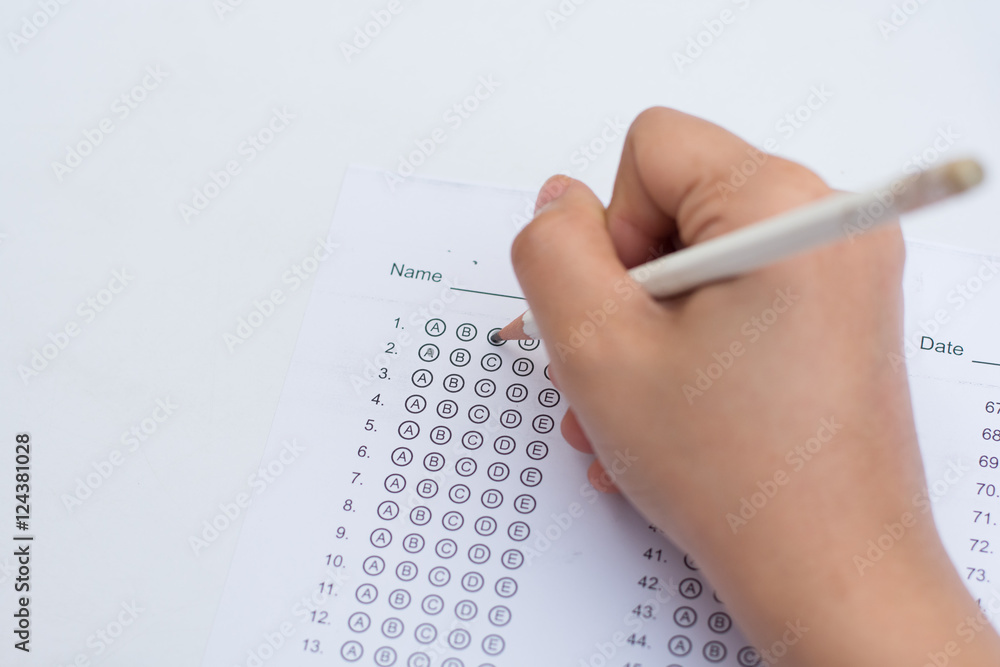 woman's hands filling in standardized test form woman's hands filling in standardized test form
