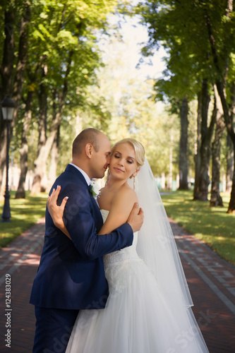 Newlyweds tenderly embraced in the park