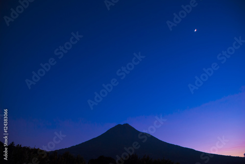 The dramatic evening sun on the roadand volcano in Guatemala © Byron Ortiz