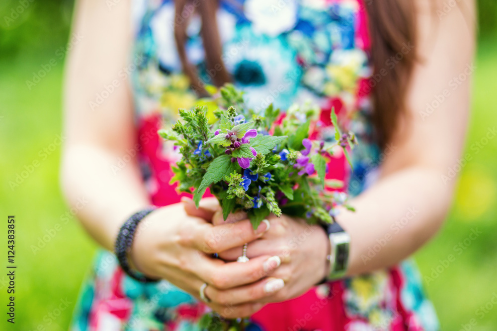 young girl holding a bouquet of wild bright colors