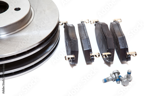 Set of new brake pads and discks isolated on white background photo