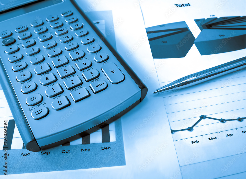 Calculator and pen on the investment chart Calculator and pen on the investment chart