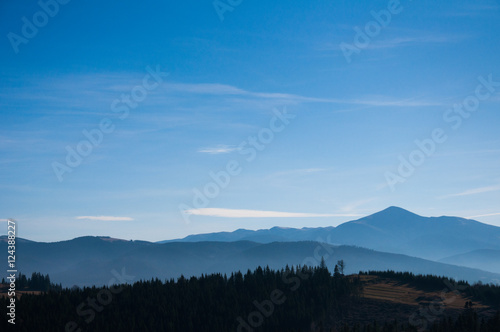 Morning fog on the mountain slopes. Carpathian Mountains. Ukraine, Europe. Color toning. Low contrast