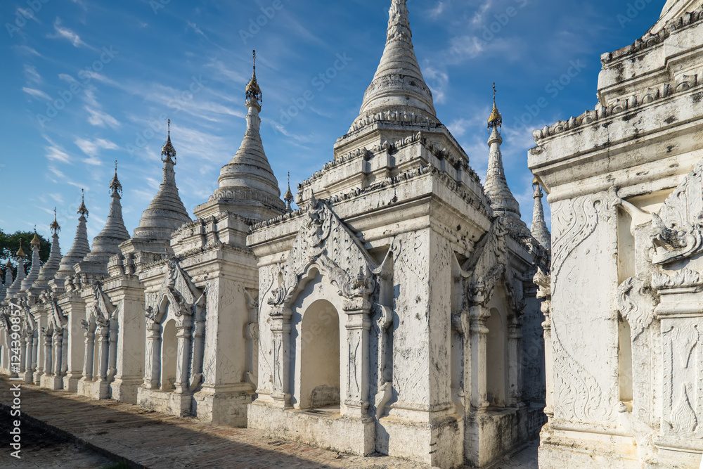 Sandamuni Pagoda with row of white pagodas. Amazing architecture of Buddhist Temples at Mandalay. Myanmar (Burma) travel landscapes and destinations