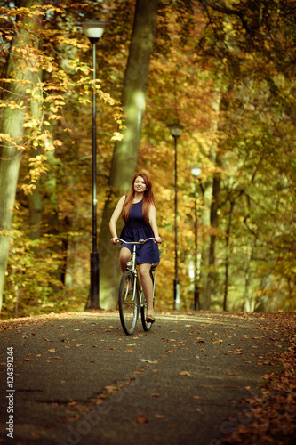 Girl in dress on bike.