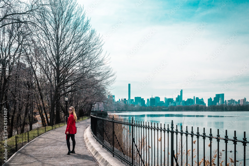 Girl walking near river at Central Park in Manhattan, New York C