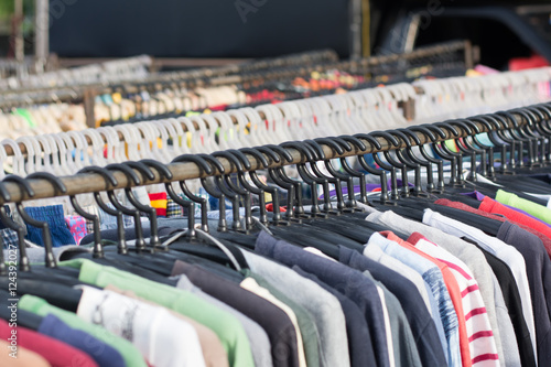 Selective focus some used leather clothes hanging on a rack in m