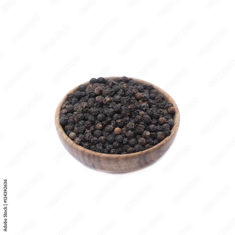 Black pepper in wooden bowl isolated on white background Black pepper in wooden bowl isolated on white background
