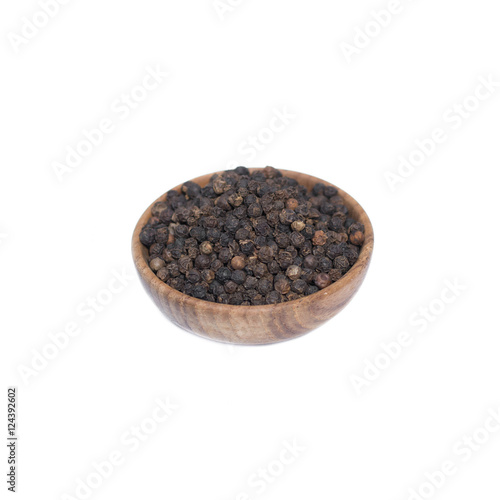 Black pepper in wooden bowl isolated on white background