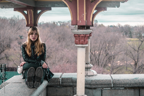 Girl sitting on edge of Belvedere Castle at Central Park in Manh photo