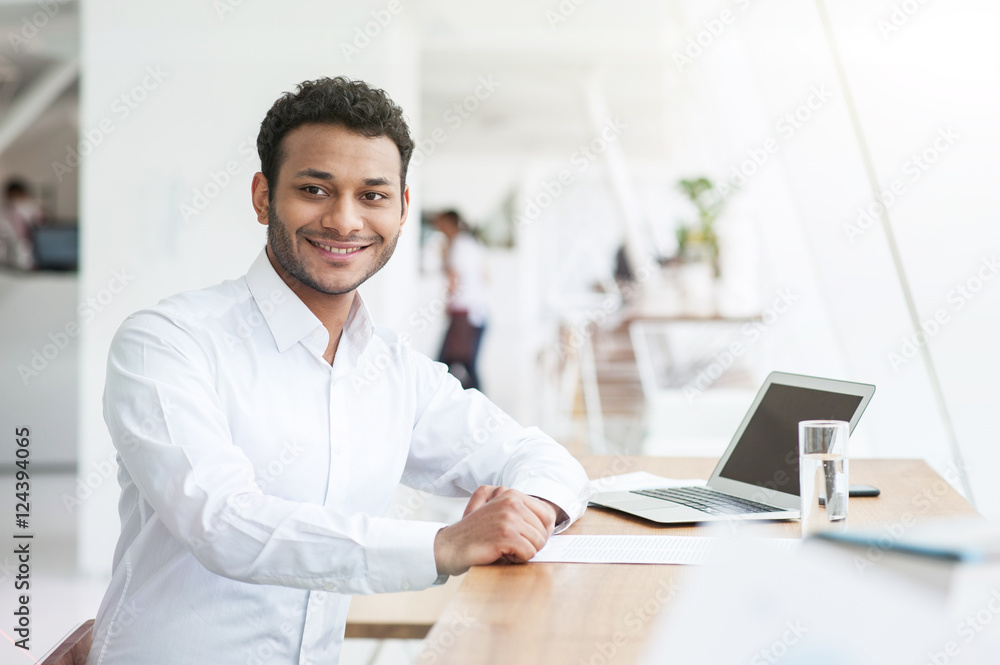 Cheerful Arabian businessman is doing his work Cheerful Arabian businessman is doing his work