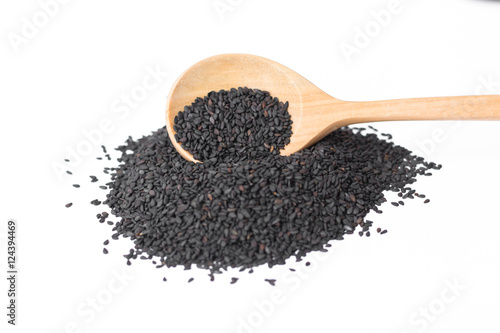 black sesame on wooden spoon isolated on white