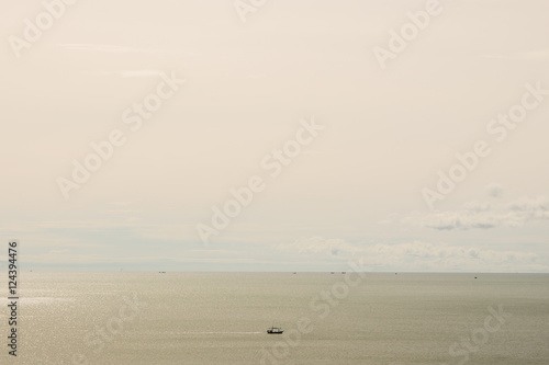 Landscape of far ocean and fishing boat.