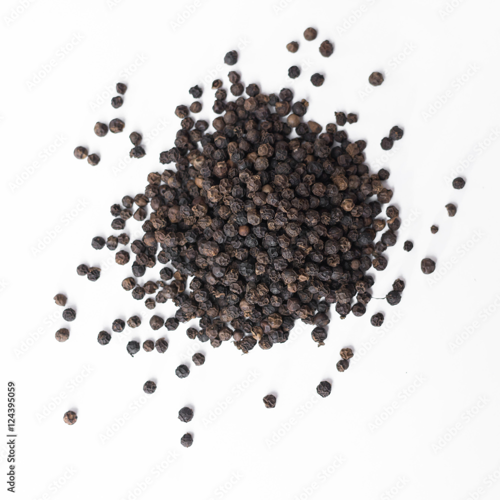 Black pepper on a white background.. Black pepper on a white background..