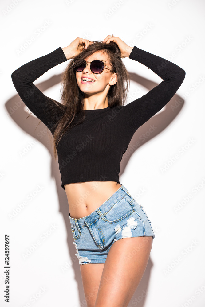 Fashion girl in sunglasses rised hands up. White background Fashion girl in sunglasses rised hands up. White background