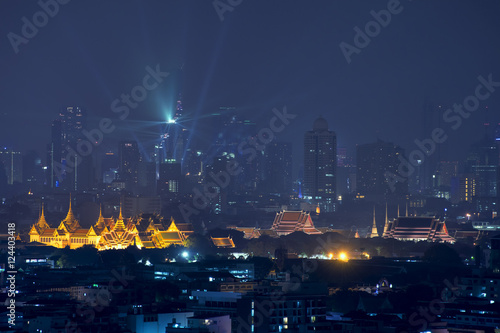 Grand palace with Bangkok skyscrapers at night in Bangkok,Thailand © ake1150