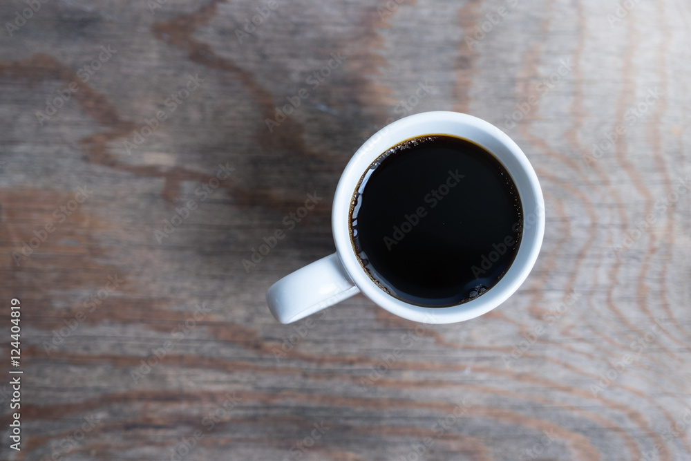 Cup of coffee on wooden table, top view Cup of coffee on wooden table, top view
