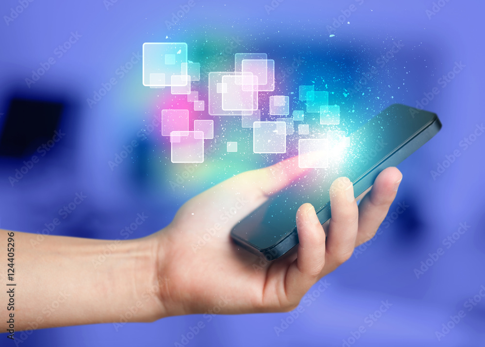 Hand holding smart phone with abstract glowing squares Hand holding smart phone with abstract glowing squares