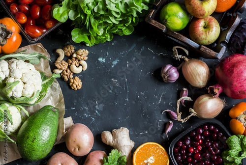 Healthy food background. Assortment of fresh vegetables and fruits on a dark background. Free space for text, top view. Flat lay