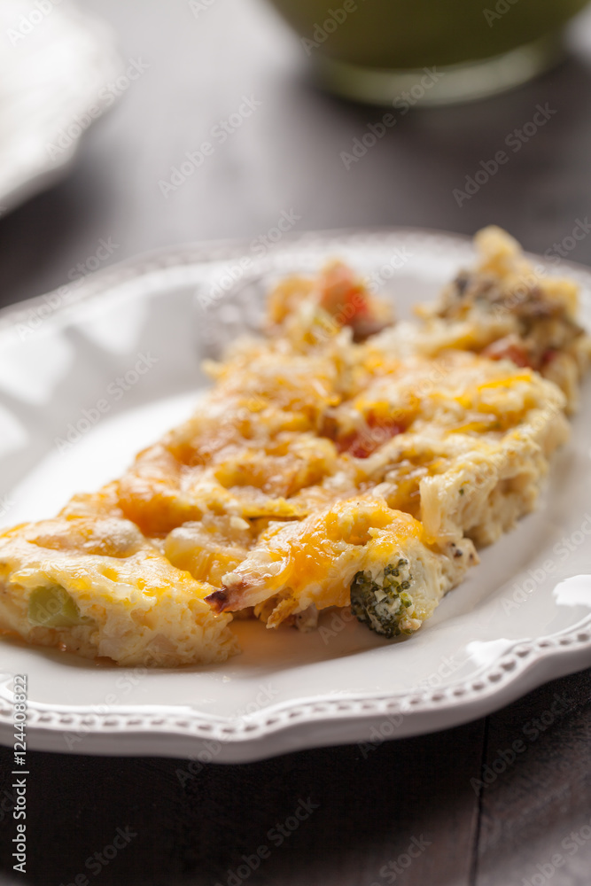 Egg omelet on small white plate with green smoothie in background