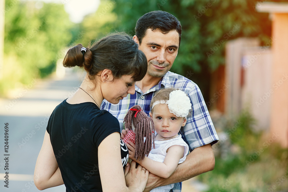 family portrait of parents and daughter outdoors family portrait of parents and daughter outdoors