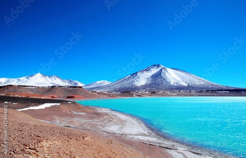 Long shot of the Laguna Verde with turquoise water  mountains in the background and a blue sunny sky in Chile  South America