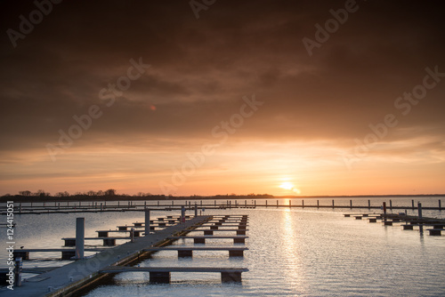 Yacht port over orange sunset