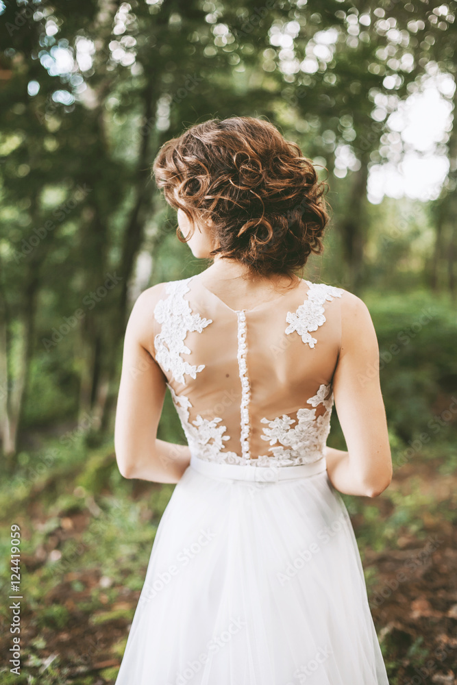 Bride`s back and details of a wedding dress and hair style