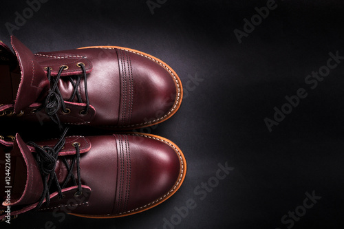 Fashionable mens leather brown shoes on black background. . Men's high boots. Top view. Copy space.