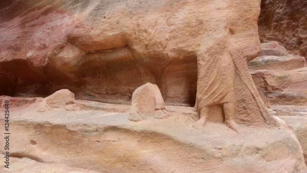 Ancient Nabataean Rock Carving Camel Rider Statue and Camel Caravans Ruins inside Al-Siq in Petra, Jordan. Petra is one the New Seven Wonders of the World. This is an UNESCO World Heritage Site. Ancient Nabataean Rock Carving Camel Rider Statue and Camel Caravans Ruins inside Al-Siq in Petra, Jordan. Petra is one the New Seven Wonders of the World. This is an UNESCO World Heritage Site.
