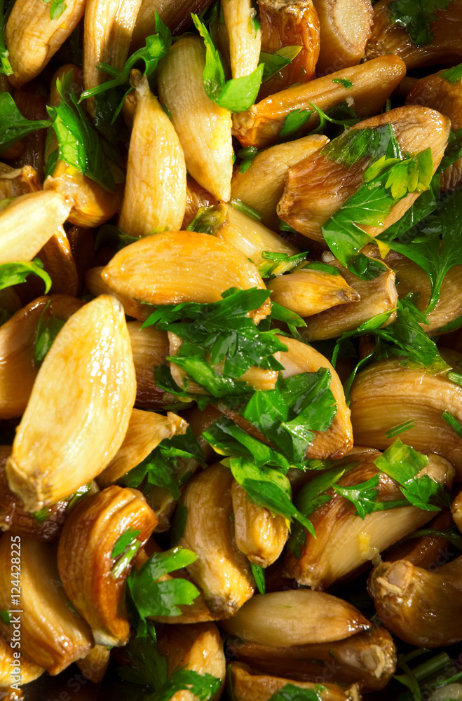 Salad with baked garlic and freshly chopped parsley. Vertical sh Salad with baked garlic and freshly chopped parsley. Vertical sh