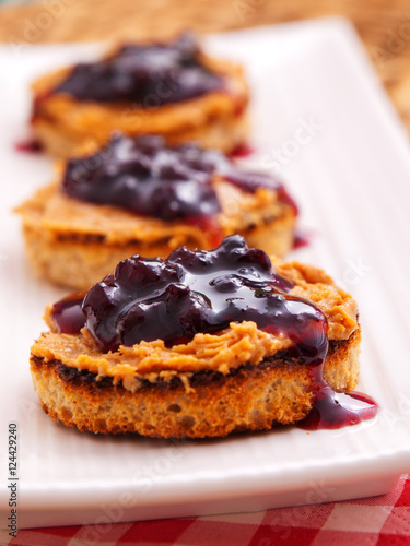 Toasts with peanut butter and cranberry jam. Vertical shot