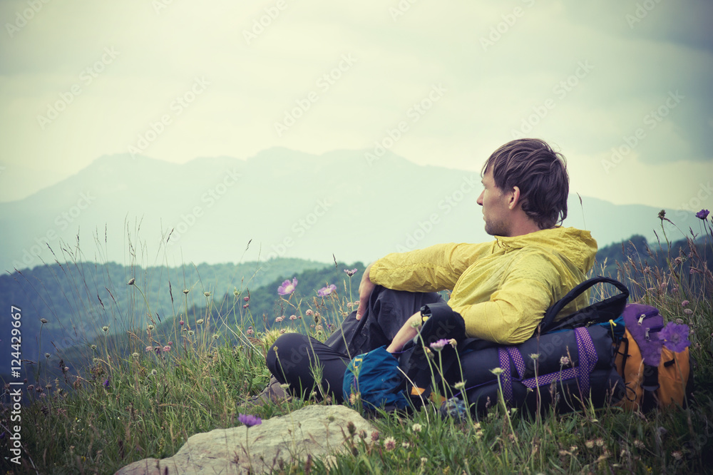 Man Traveler with backpack relaxing with Mountains on Background Summer Traveling Outdoor Man Traveler with backpack relaxing with Mountains on Background Summer Traveling Outdoor