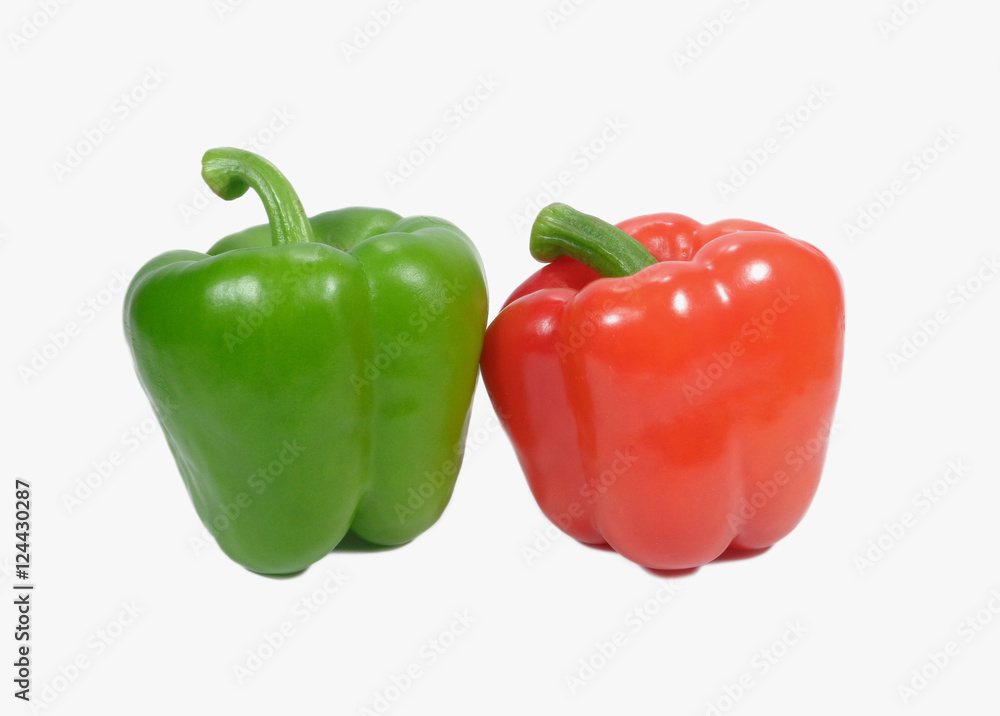 Close up of two ripe bell peppers with stem, one red and one green isolated on white background Close up of two ripe bell peppers with stem, one red and one green isolated on white background