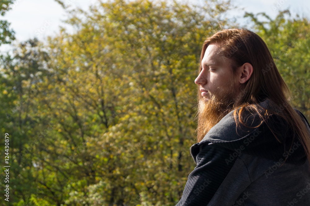 Portrait of man with a long beard and a long hair gone with the