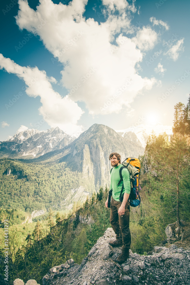 Young Man Traveler with backpack relaxing outdoor with rocky mountains on background Summer vacations and Lifestyle hiking concept