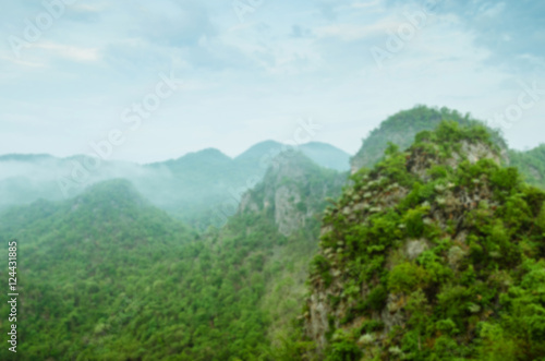 Blurry Background of Greenery of Mountain In Foggy Morning.