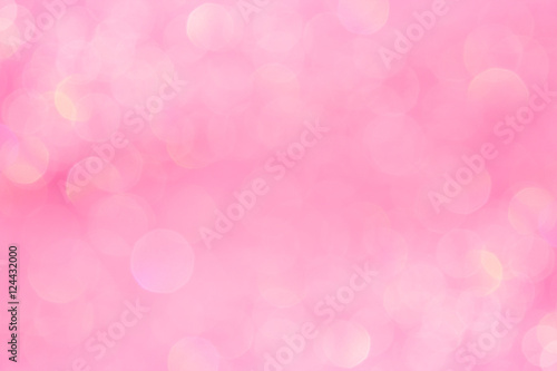Bokeh soft pastel pink background with blurred golden lights. Festive background.