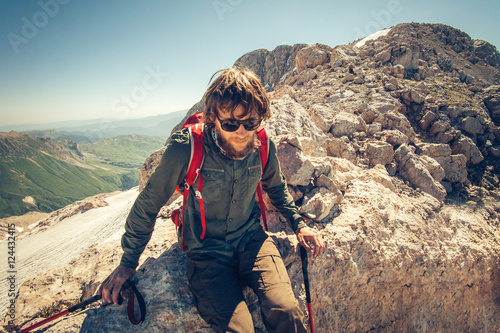 Man Traveler bearded with backpack relaxing Travel Lifestyle concept mountains on background Summer vacations activity outdoor