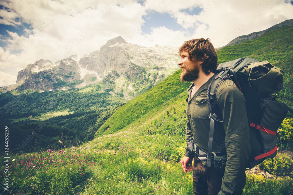 Bearded Man with backpack hiking Travel Lifestyle concept mountains on background Summer journey adventure vacations outdoor