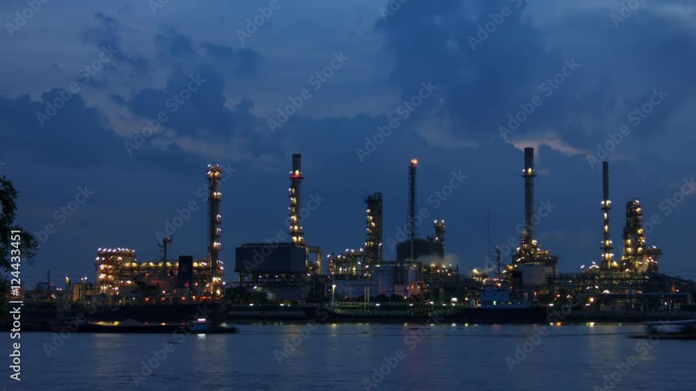 Oil refinery on the river and waterways in night to sunrise .Time lapse shot. Oil refinery on the river and waterways in night to sunrise .Time lapse shot.